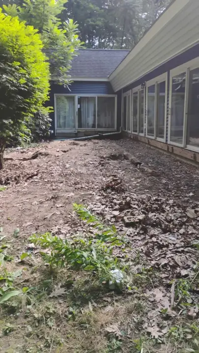 Bare ground along the house after the backyard deck was fully removed