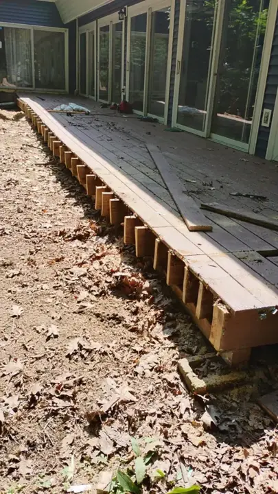 Backyard deck boards removed down to the joists during demolition