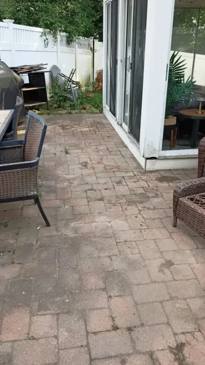 Open paver patio beside a sunroom after the cleanout was finished